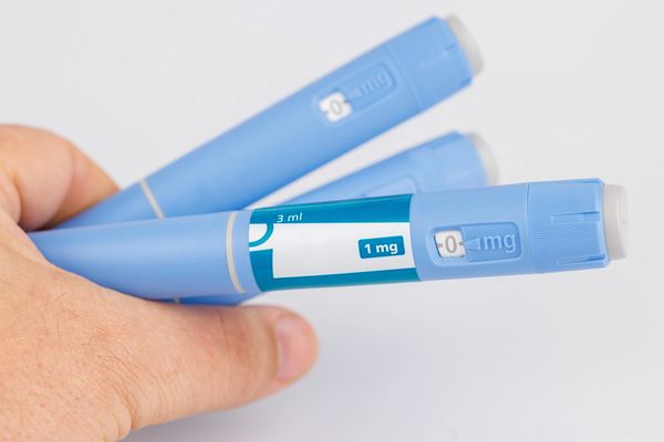 Close-up of a GLP-1 medication pen used for weight loss treatment.