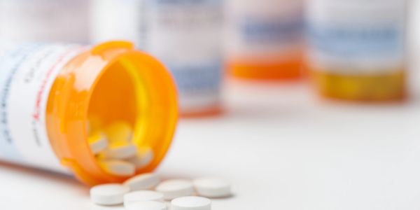 Close-up of white tablets used for oral weight loss medication treatment.